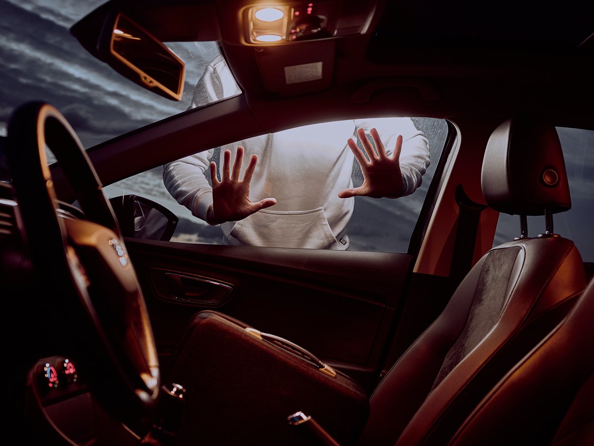 image of person outside car with their hands on the window